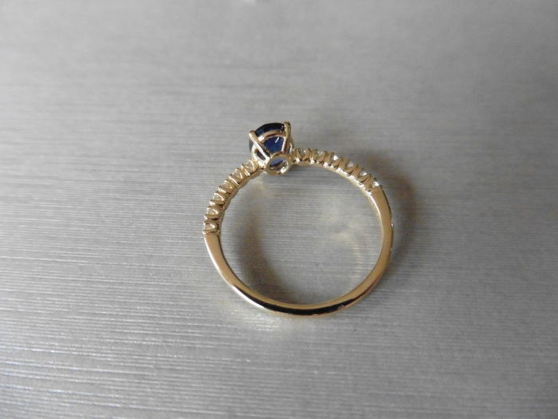 0.80ct / 0.12ct sapphire and diamond dress ring. Oval cut ( glass filled) sapphire with small - Image 2 of 3