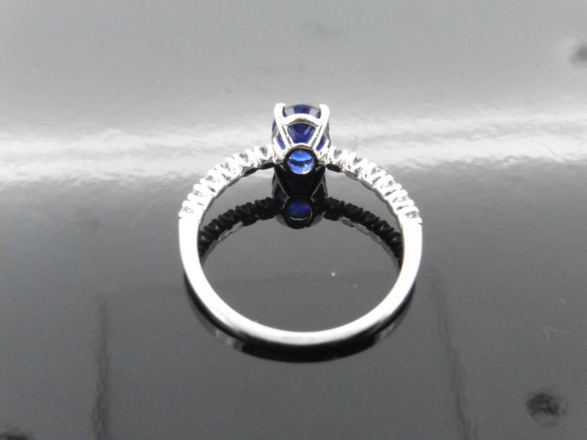 0.80ct / 0.12ct sapphire and diamond dress ring. Oval cut ( treated ) sapphire with small diamonds - Image 2 of 3
