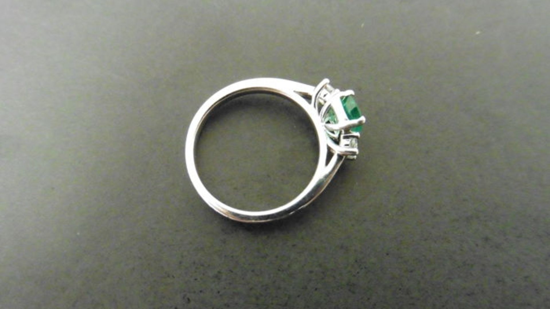 0.80ct emerald and diamond trilogy ring. 7x 5mm oval cut emerald ( oil treated) with a small diamond - Image 2 of 4