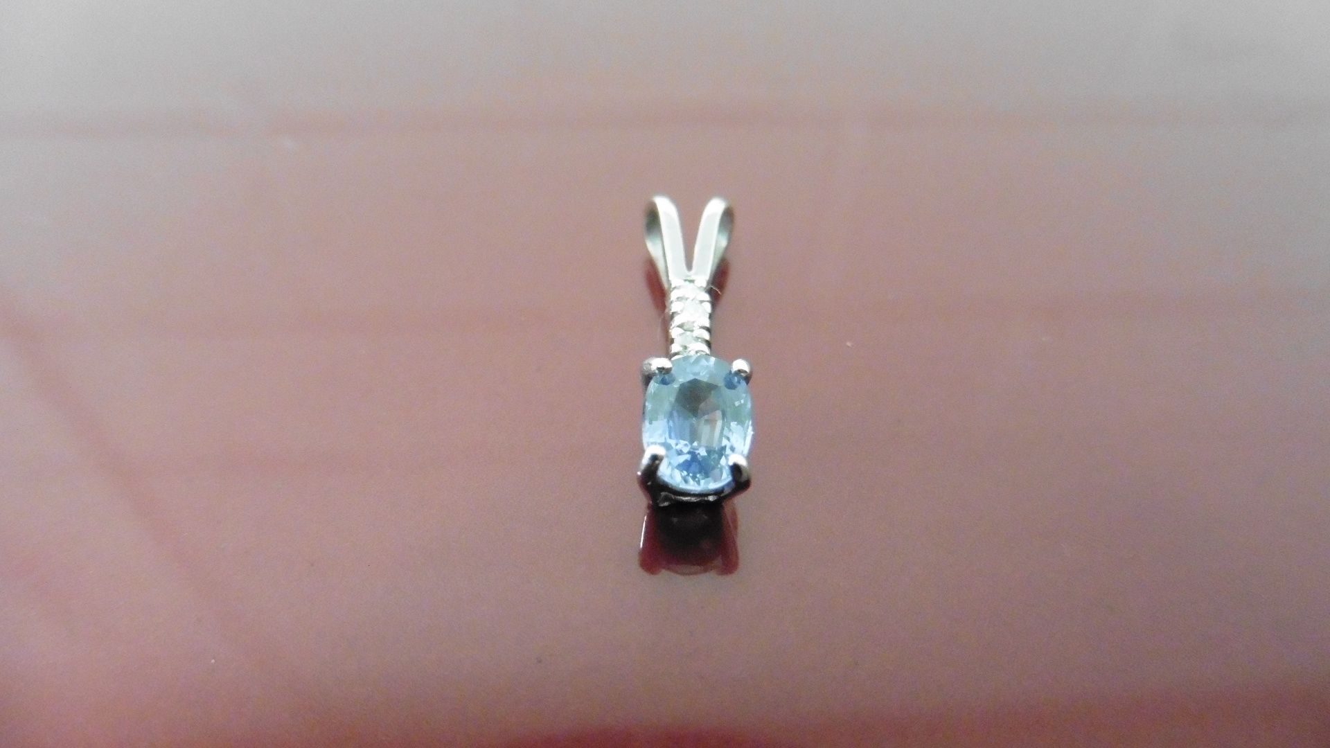 Ceylon Sapphire and diamond drop style pendant. Oval cut sapphire, 6 x 4mm and 4 brilliant cut