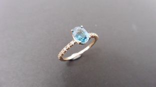 0.80ct / 0.12ct blue zircon and diamond dress ring. Oval cut ( treated ) zircon with small