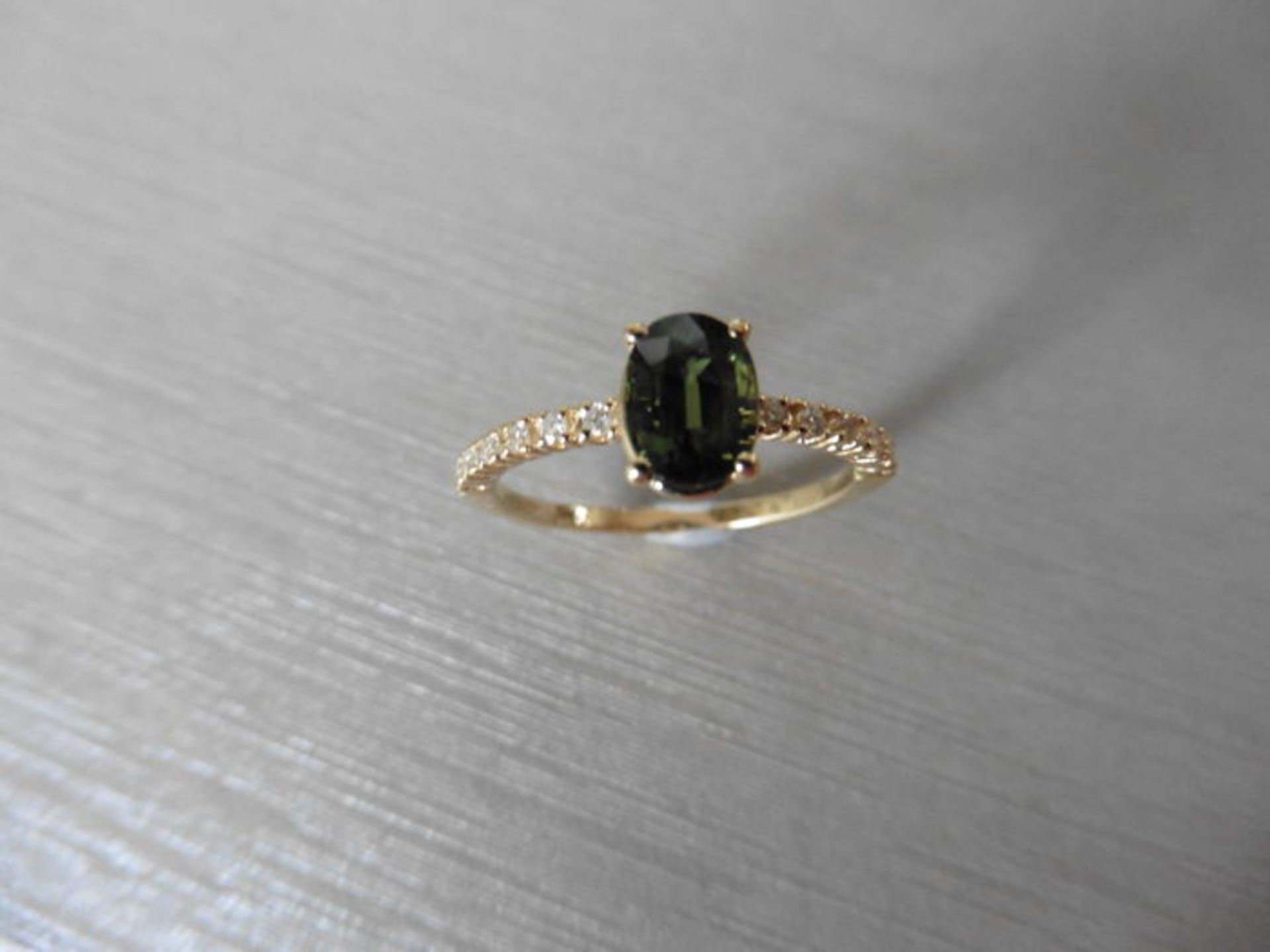 0.80ct / 0.12ct green sapphire and diamond dress ring. Oval cut ( treated ) sapphire with small - Image 2 of 3