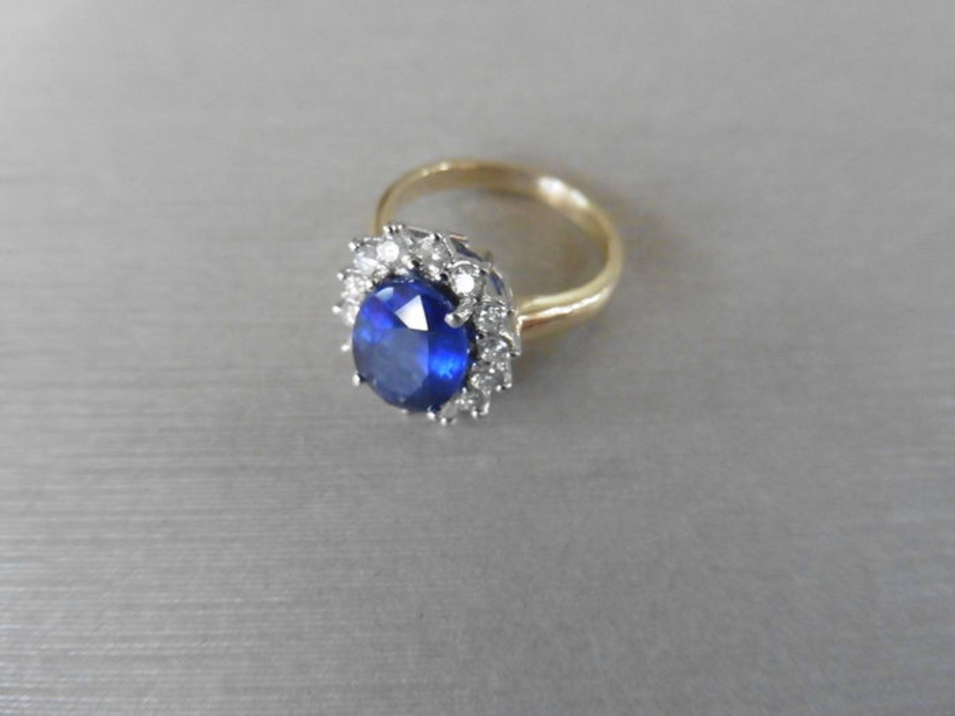 2.40ct sapphire and diamond cluster ring set with a oval cut (glass filled) sapphire which is - Image 2 of 3