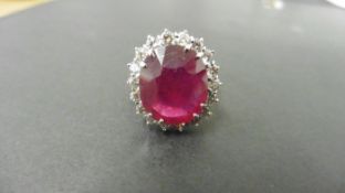 9ct ruby and diamond cluster ring. Oval cut ruby( glass filled) in the centre surrounded by