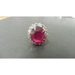 9ct ruby and diamond cluster ring. Oval cut ruby( glass filled) in the centre surrounded by