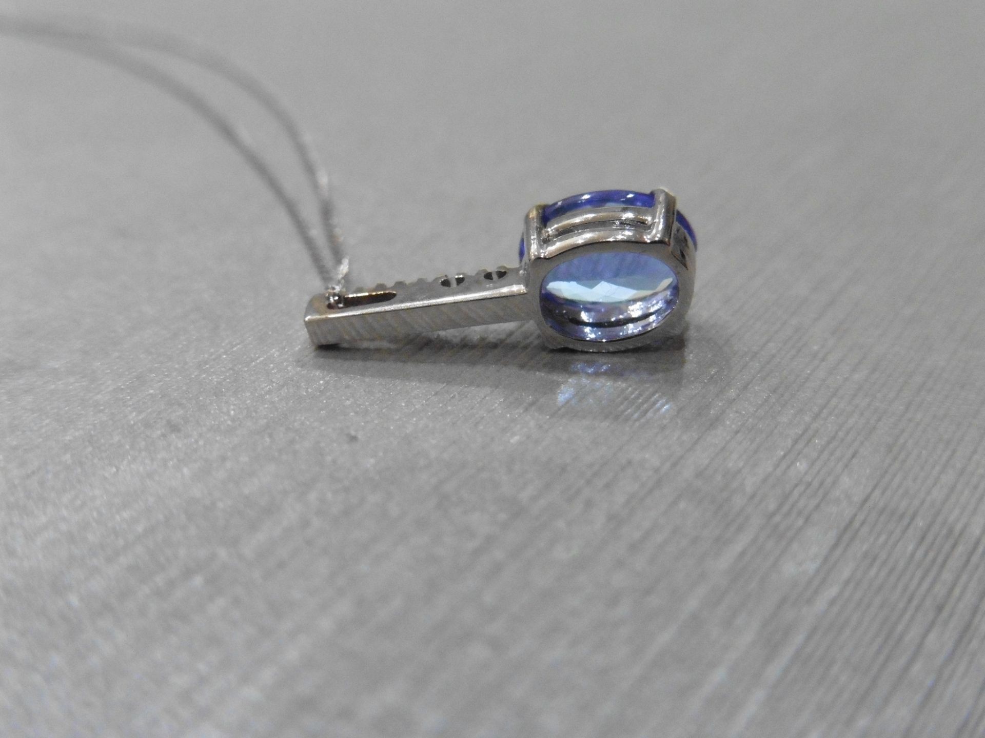 0.80ct tanzanite and diamond drop style pendant. 7X 5mm oval tanzanite set with 5 small brilliant - Image 2 of 3
