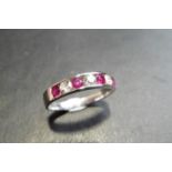 Ruby and diamond eternity band ring set in 9ct white gold. 4 small round cut rubies ( treated )0.