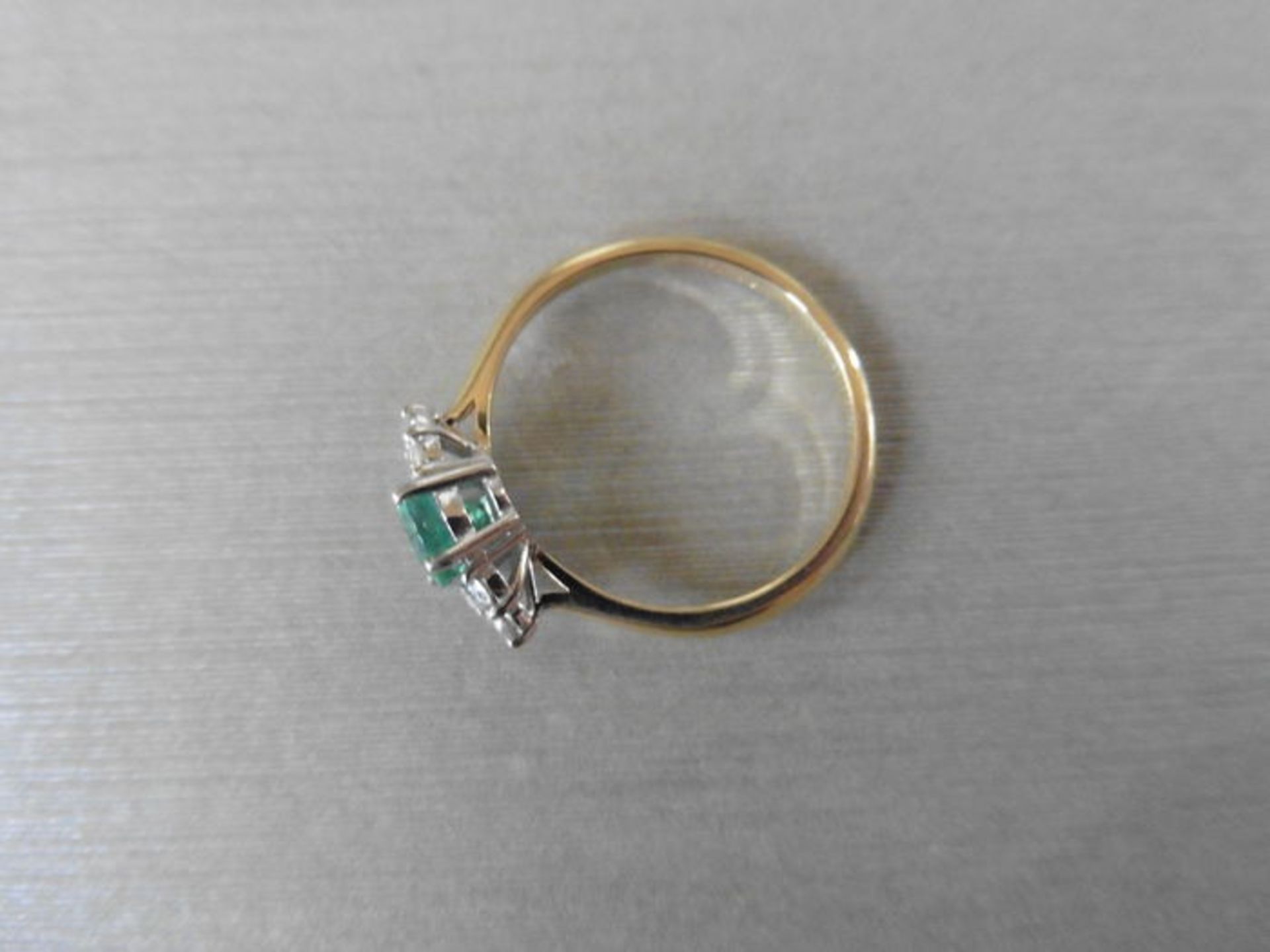0.80ct emerald and diamond dress ring. 7x 5mm oval cut emerald (treated) with 3 small diamonds set - Image 3 of 3