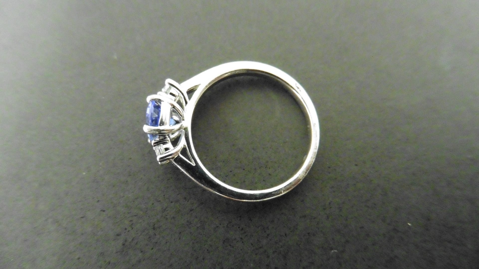 0.80ct tanzanite and diamond trilogy ring. 7x 5mm oval cut tanzanite (treated) with a small - Image 2 of 4