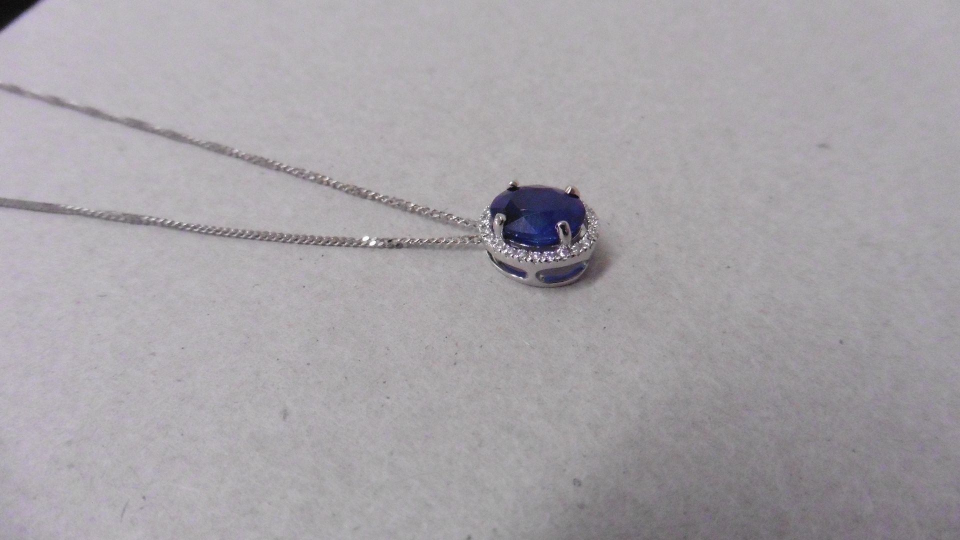 0.80ct halo set diamond pendant. Oval cut sapphire ( glass filled ) in the centre, 0.80ct, with a - Image 2 of 3