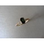 0.80ct / 0.12ct green sapphire and diamond dress ring. Oval cut ( treated ) sapphire with small