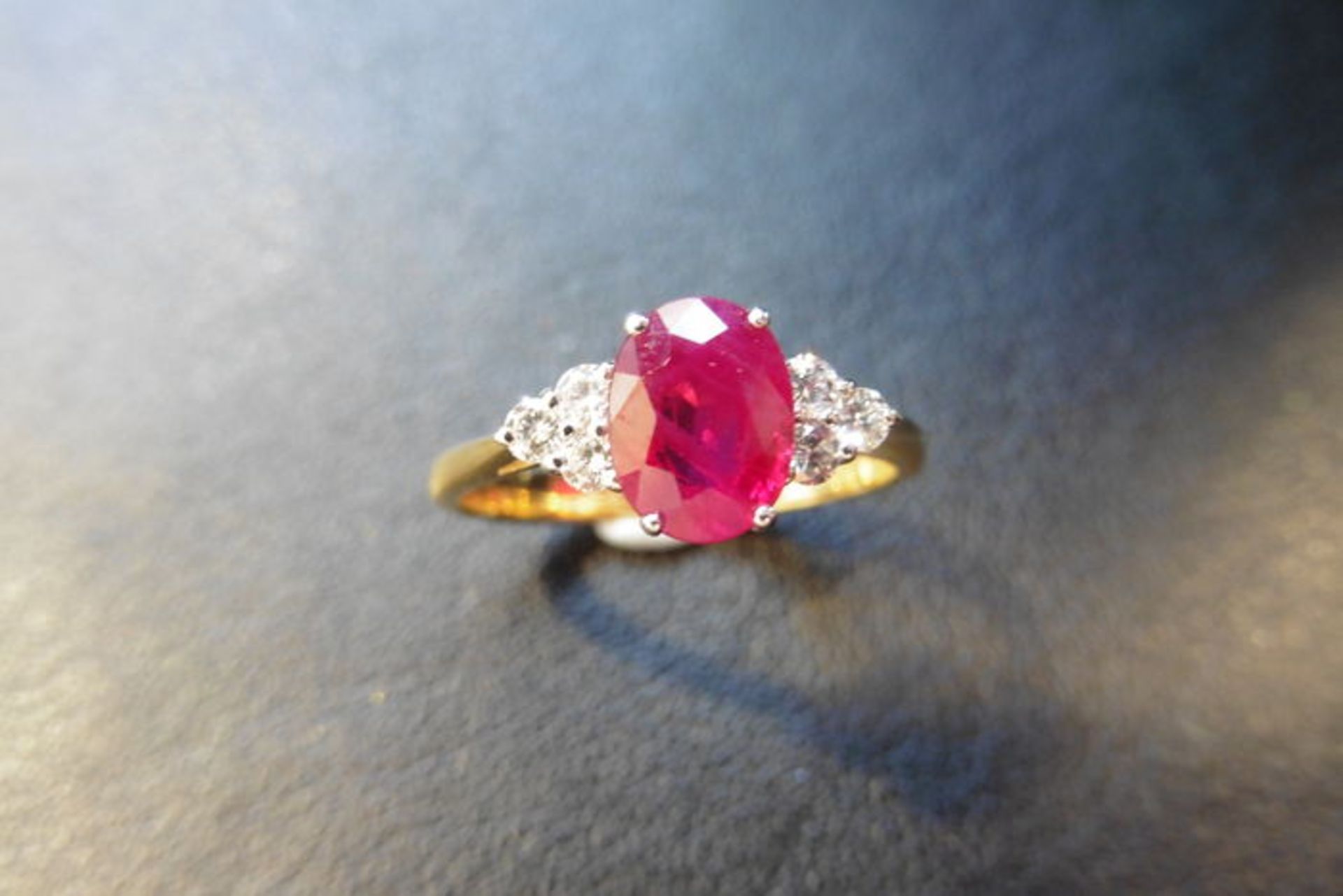0.80ct ruby and diamond dress ring. 7x 5mm oval cut ruby (treated) with 3 small diamonds set - Image 3 of 3