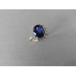 2.40ct sapphire and diamond cluster ring set with a oval cut (glass filled) sapphire which is