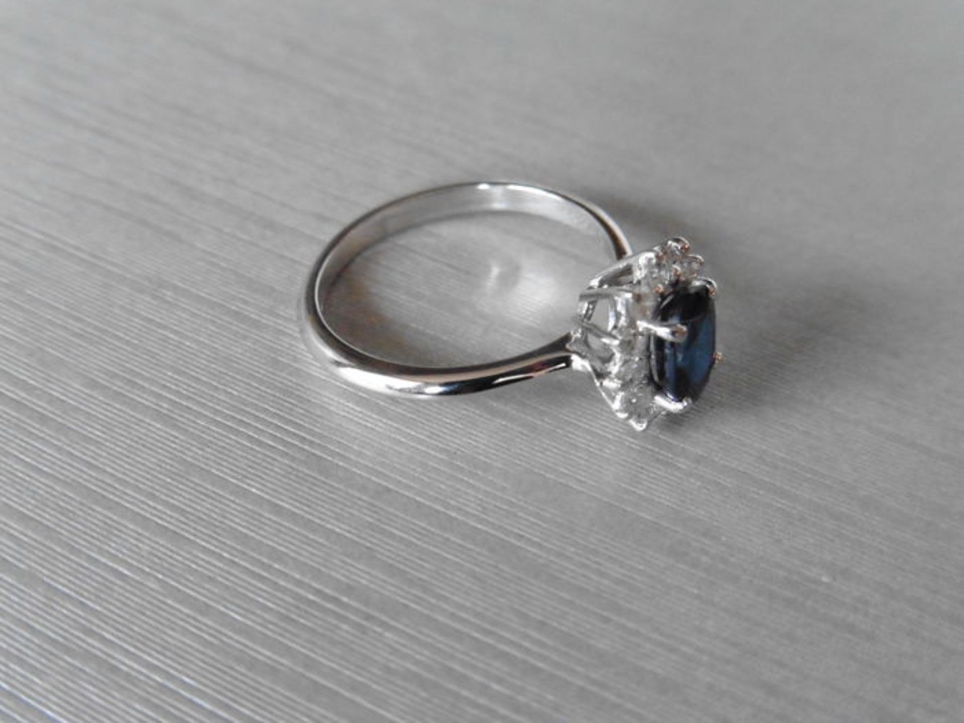 0.80ct sapphire and diamond cluster ring set with a oval cut(glass filled) sapphire which is - Image 2 of 3