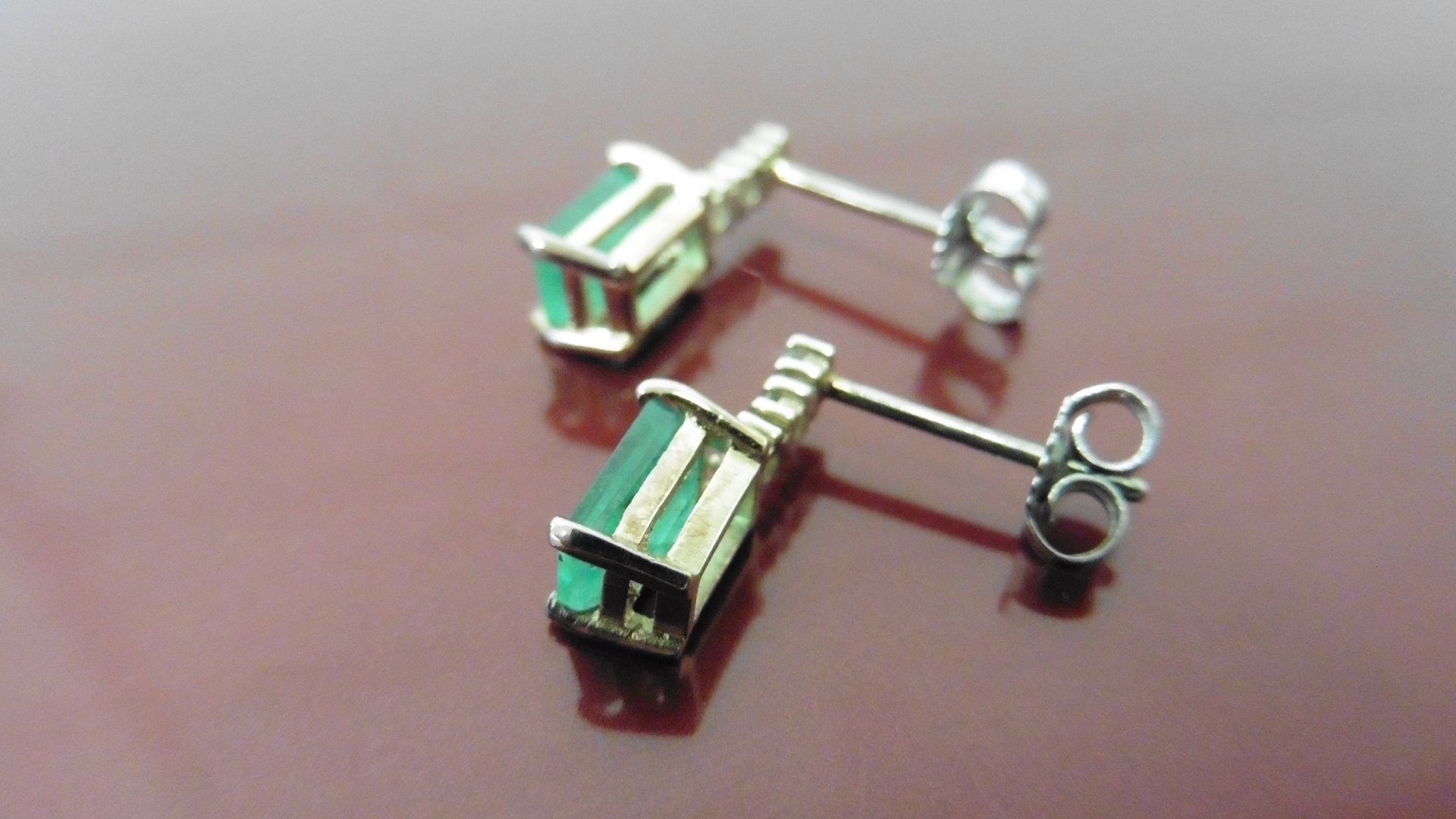 Emerald and diamond drop style earrings each set with an rectangular cut emerald, 6x4mm, weighing - Image 2 of 3