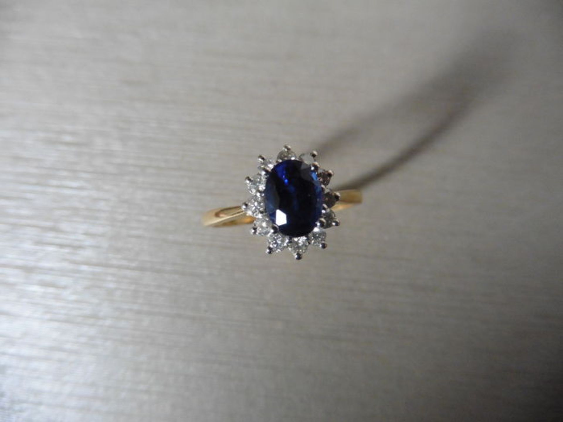 0.80ct sapphire and diamond cluster ring set with a oval cut (glass filled) sapphire which is - Image 4 of 4