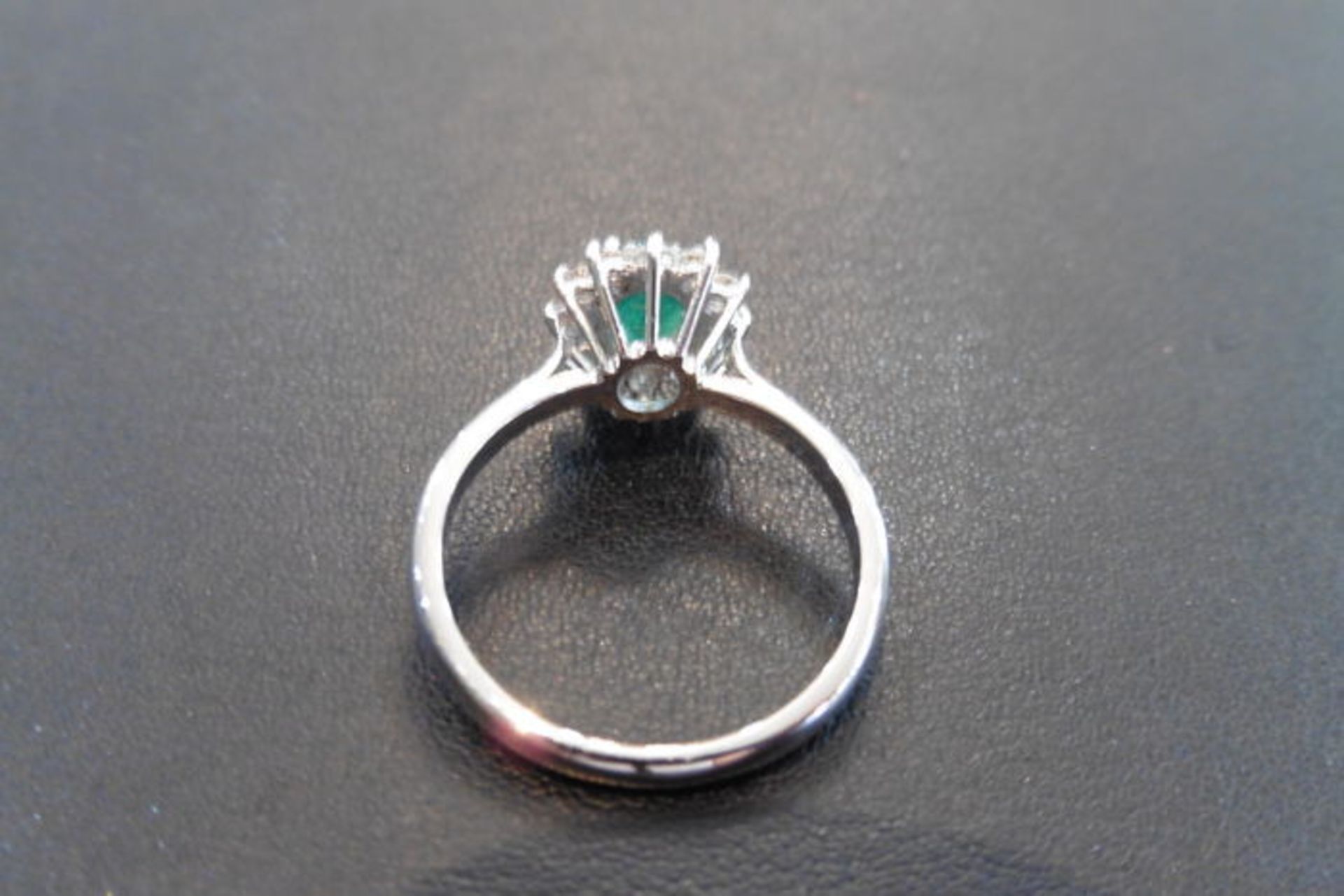 0.80ct emerald and diamond cluster ring set with a oval cut( treated) emerald which is surrounded by - Image 2 of 3