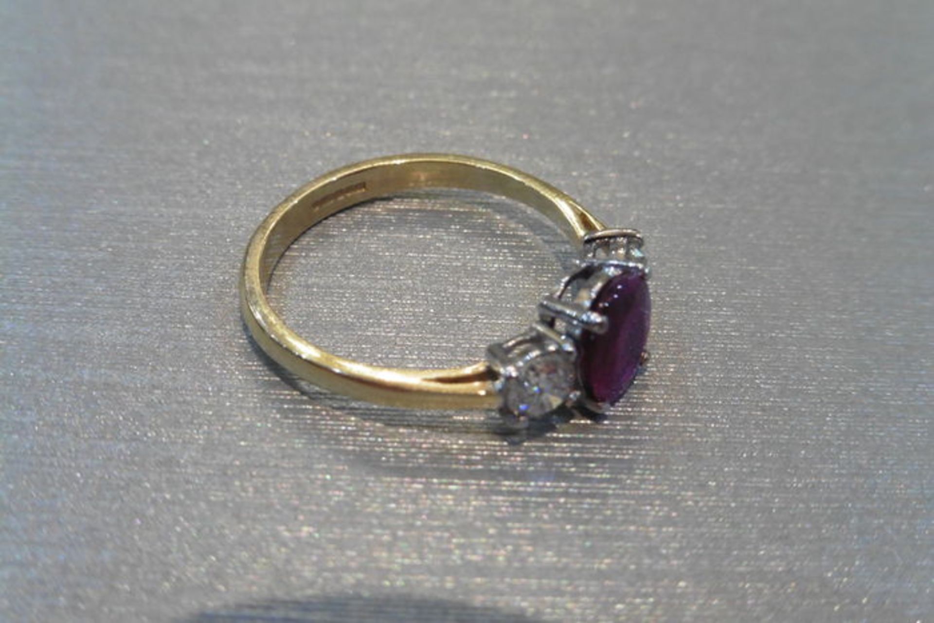 Ruby and diamond trilogy ring. Oval cut ( glass filled ) ruby weighing 2.40ct with a brilliant cut - Image 2 of 3