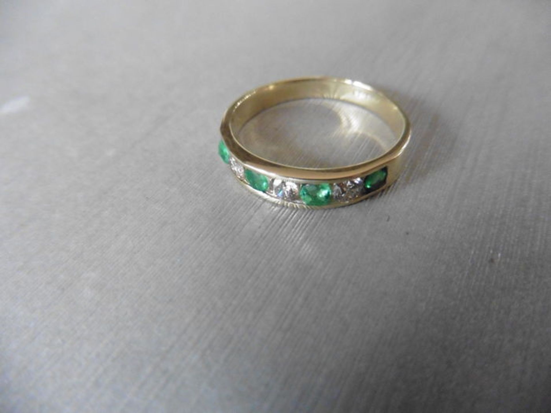 Emerald and diamond eternity style ring. Set with 4 round cut emeralds ( treated )0.40ct and 3 - Image 2 of 3