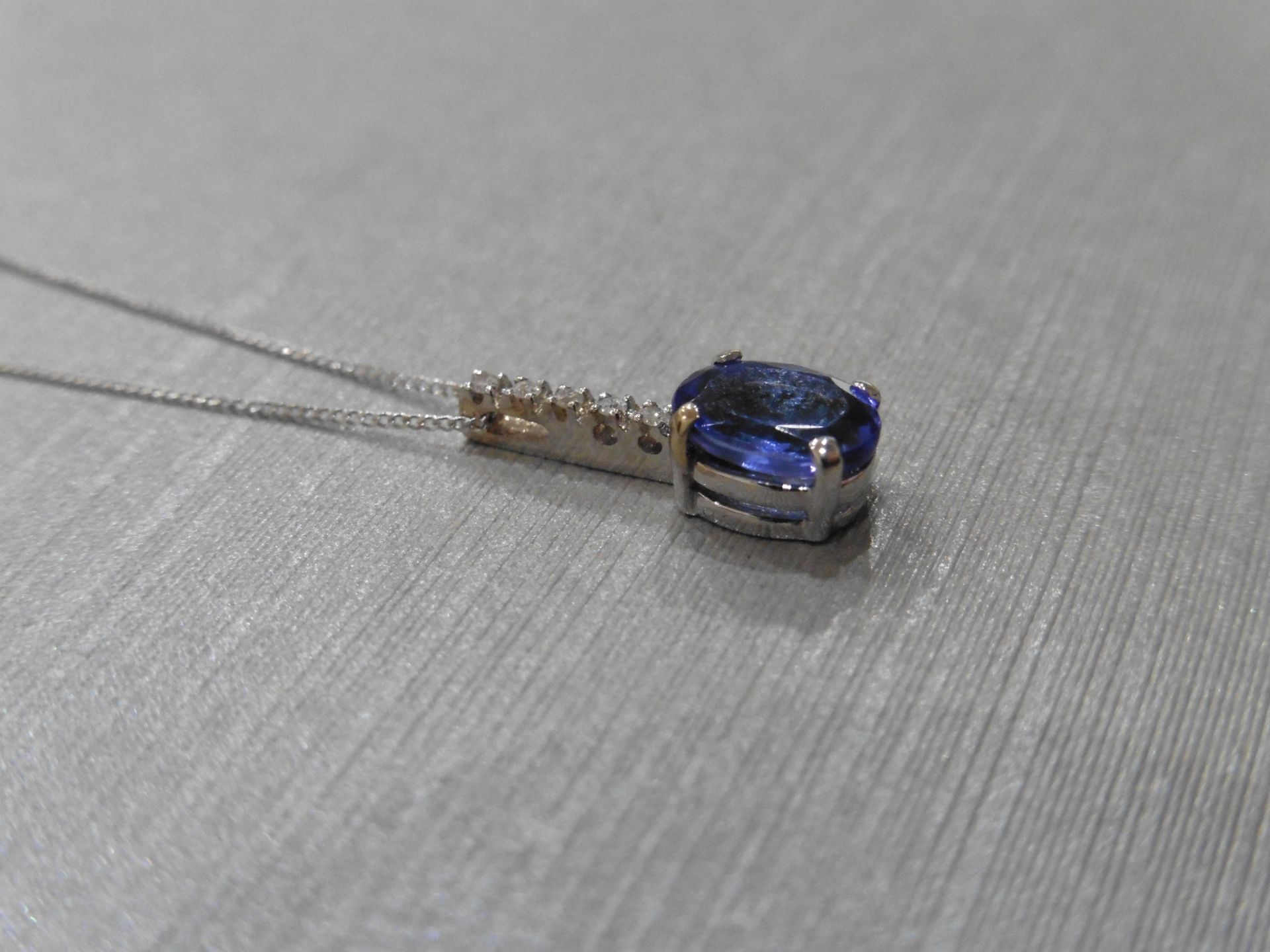 0.80ct tanzanite and diamond drop style pendant. 7X 5mm oval tanzanite set with 5 small brilliant - Image 3 of 3