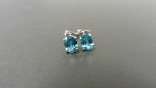 1.60ct zircon stud style earrings set in 9ct white gold. 7 x 5mm oval cut blue zircons set in a 4