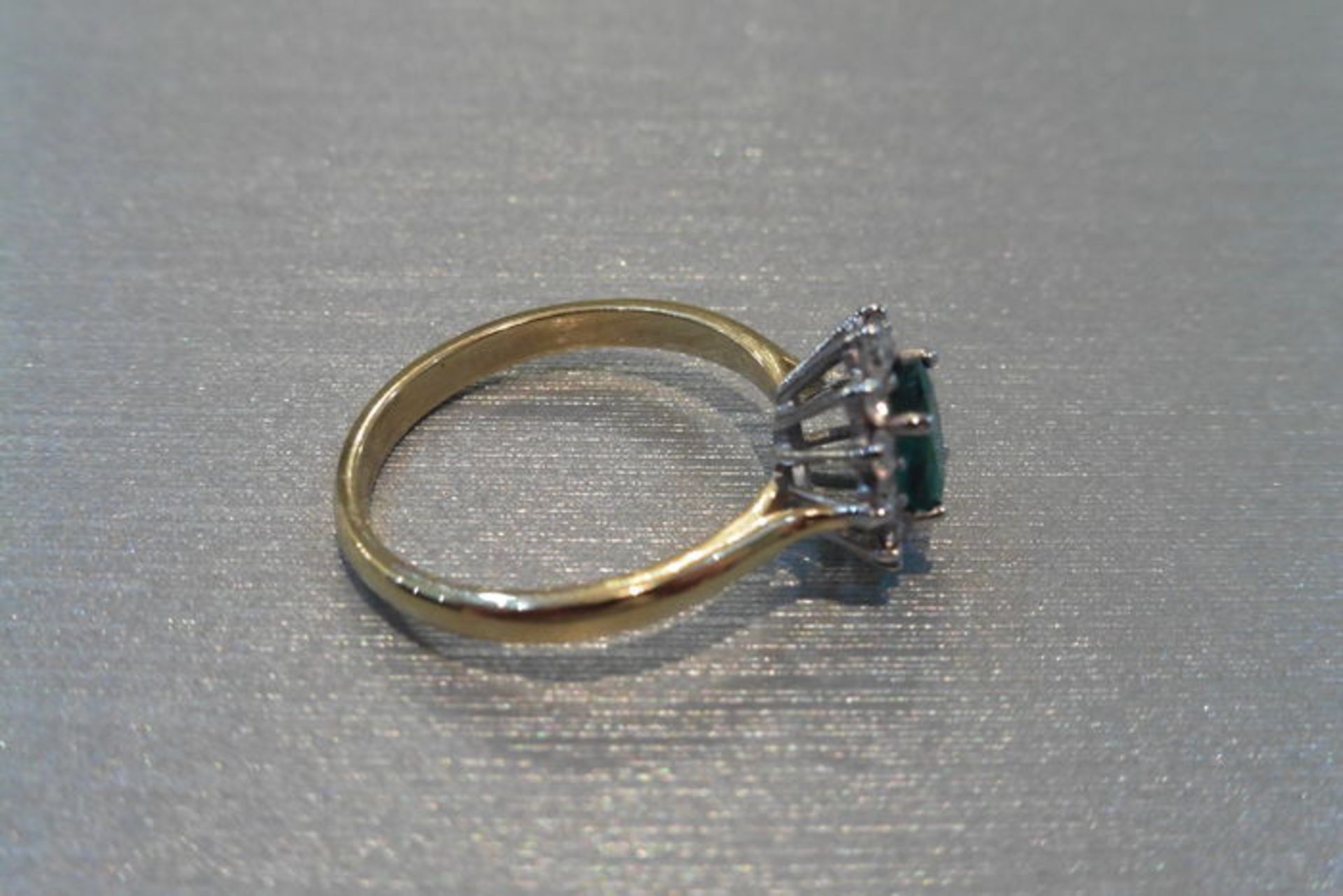 0.80ct emerald and diamond cluster ring set with a oval cut (treated) emerald which is surrounded by - Image 2 of 3