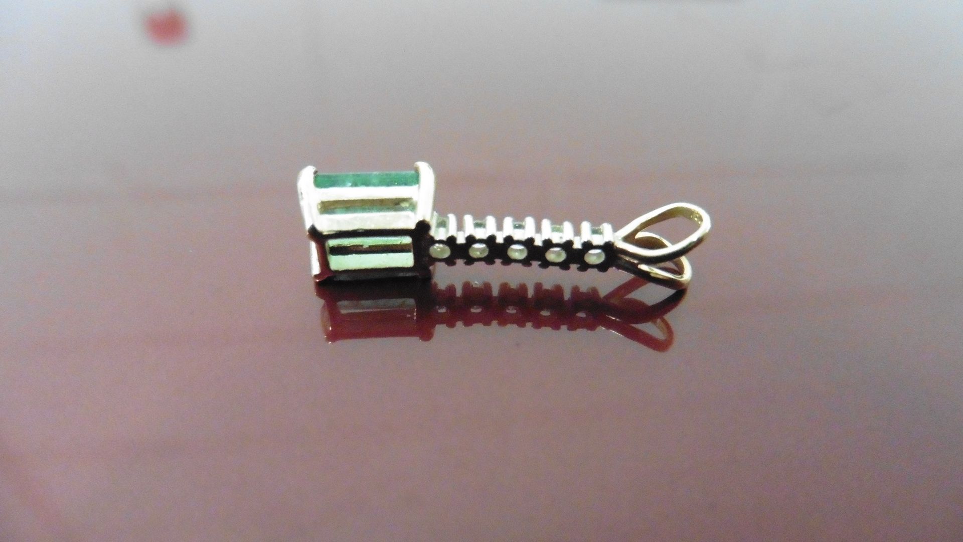 Emerald and diamond drop style pedant. Set with an rectangular cut emerald, 6x4mm, weighing - Image 2 of 3