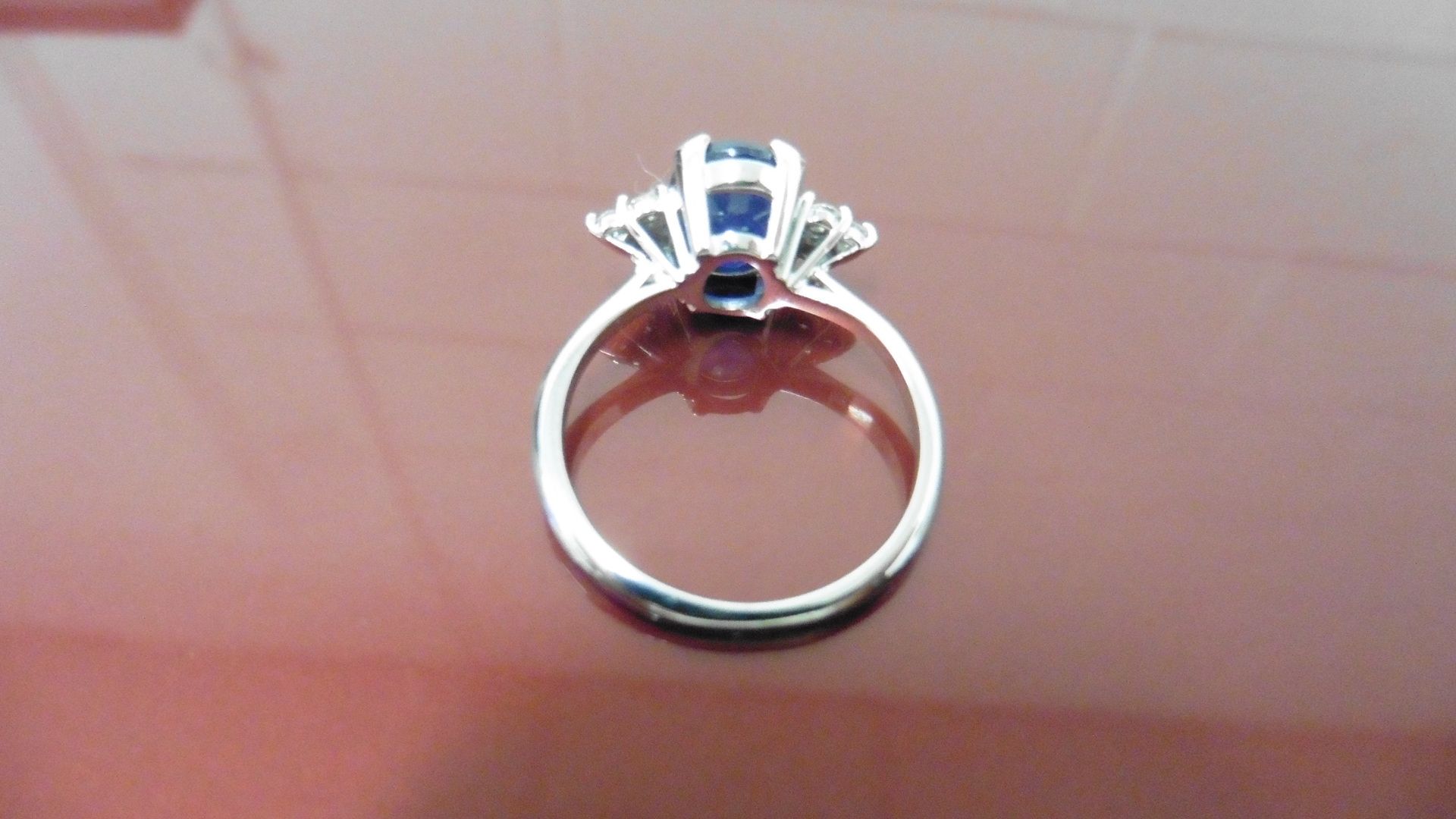 2.40ct Sapphire and diamond dress ring. Oval cut ( glass filled ) sapphire with 3 small brilliant - Image 2 of 3