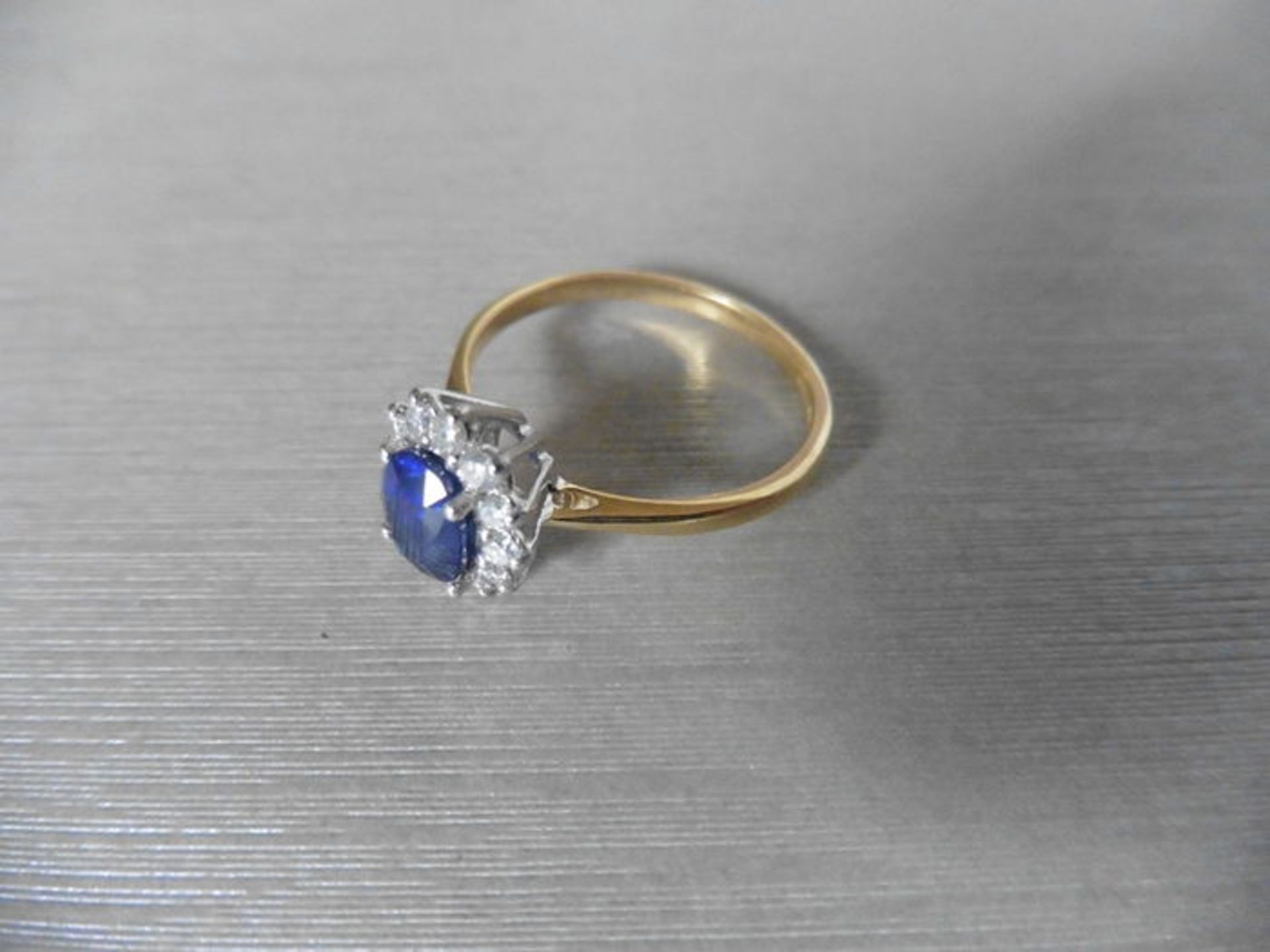 0.80ct sapphire and diamond cluster ring set with a oval cut (glass filled) sapphire which is - Image 3 of 4