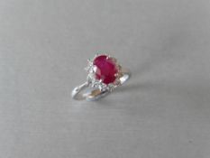 0.80ct Ruby and diamond cluster ring set with a oval cut(glass filled) ruby which is surrounded by