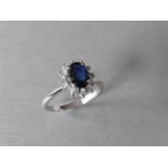 0.80ct sapphire and diamond cluster ring set with a oval cut(glass filled) sapphire which is