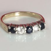 9ct gold ring with blue and white stones set in a silver mount - Birmingham hallmarks - size M.