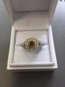 1.15ct diamond set solitaire ring with a yellow cushion cut yellow diamond and a halo setting and