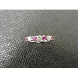 Ruby and diamond eternity band ring set in platinum. 4 round cut ( treated ) rubies and 3