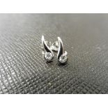 0.20ct diamond swirl style earrings set in platinum 950. 2 small brilliant cut diamonds, H/I