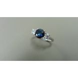 Sapphire and diamond trilogy ring. 5mm round cut sapphire ( treated ) with a brilliant cut diamond