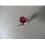 Ruby and diamond dress ring set in platinum. Oval cut ruby ( glass filled ) 2.40ct approx with 3