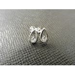 0.10ct diamond tear drop earrings set in platinum 950. 2 small brilliant cut diamonds, H colourand