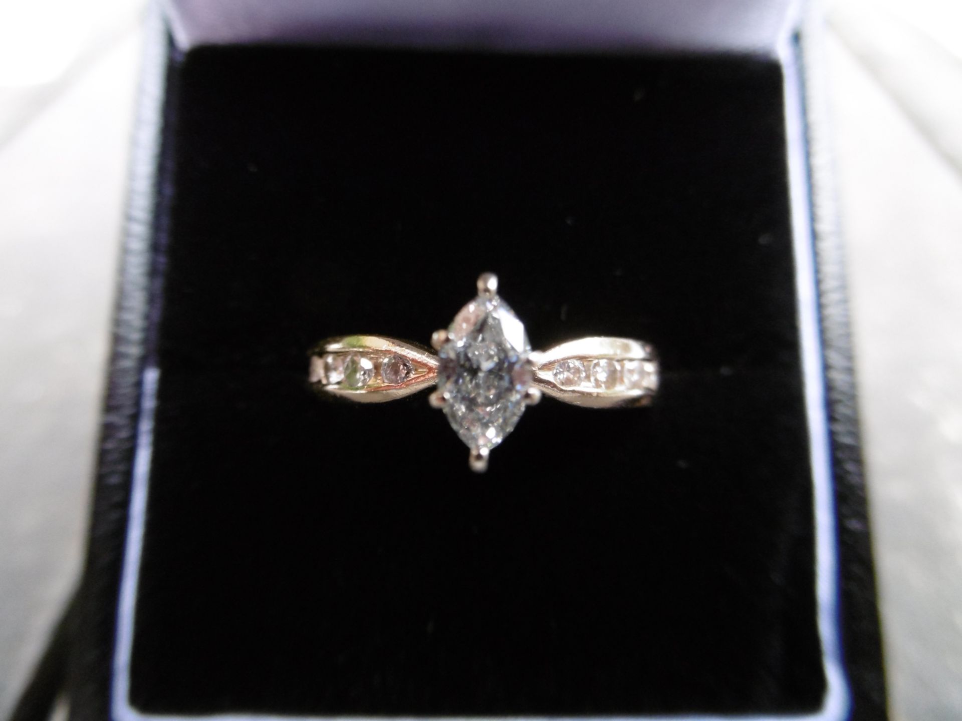 14ct Gold Marquise cut Diamond ring. 0.48ct plus 4 small round cut Diamonds on each shoulder