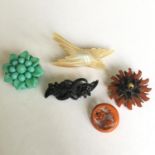 A good selection of vintage carved Bakelite and Lucite brooches
