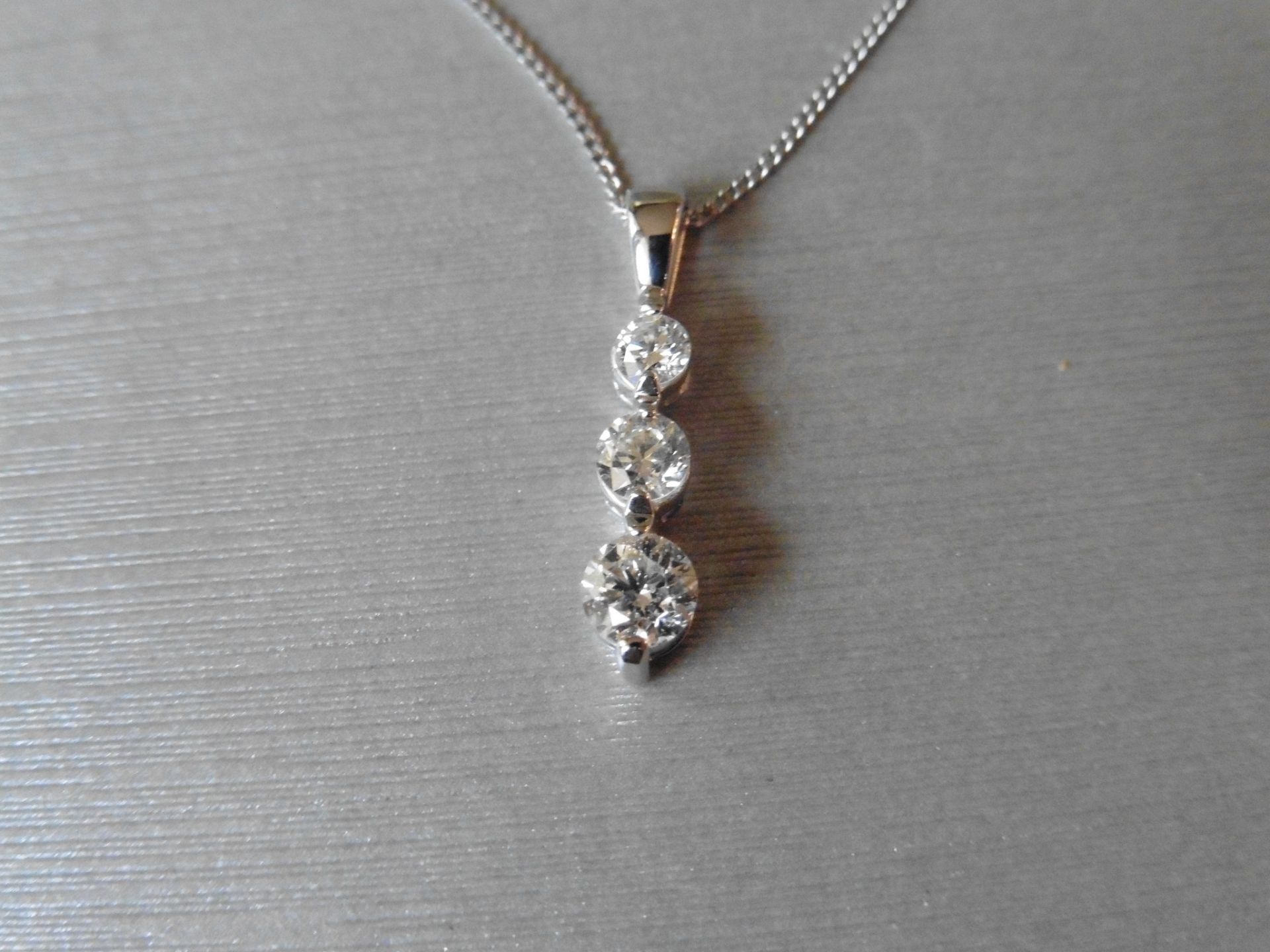 0.75ct Trilogy style pendant set with 3 graduated brilliant cut diamonds, I colour, Si3 clarity. Set