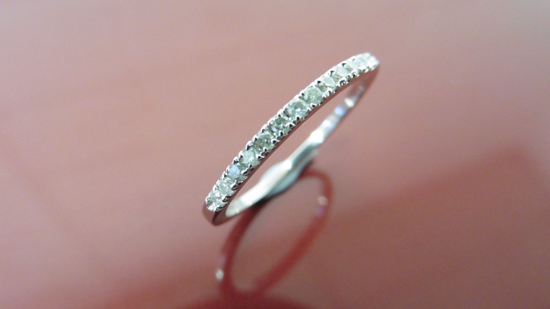 0.13ct diamond band ring set in 14ct white gold. Small brilliant cut diamonds, I colour and i1