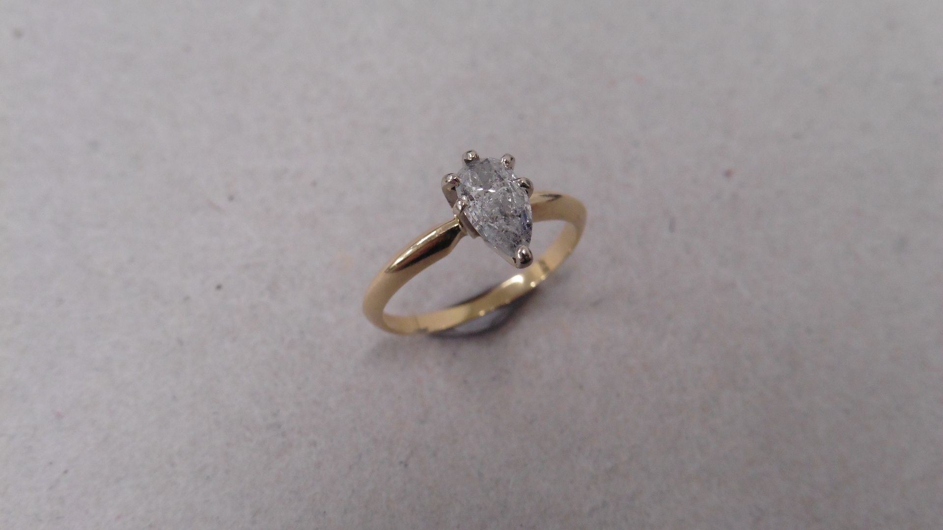 14ct gold diamond solitaire ring set with a pear shaped diamond J colour, I1 clarity. 6 claw setting