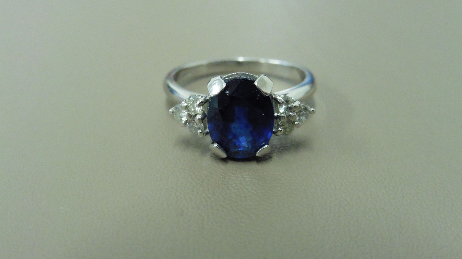2.50ct sapphire and diamond dress ring. 9x7 oval cut ( glass filled ) with 3 small brilliant cut - Image 3 of 3