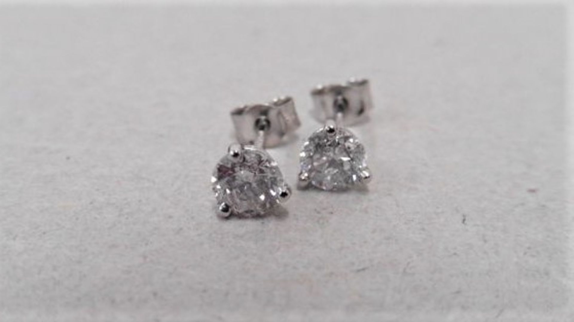 1.00ct diamond solitaire earrings set in platinum. 2 x brilliant cut diamonds, 0.50ct ( enhanced ) H