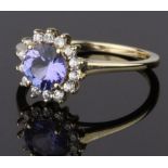 9CT GOLD CLUSTER RING, COMPRISING A RAISED BLUE STONE