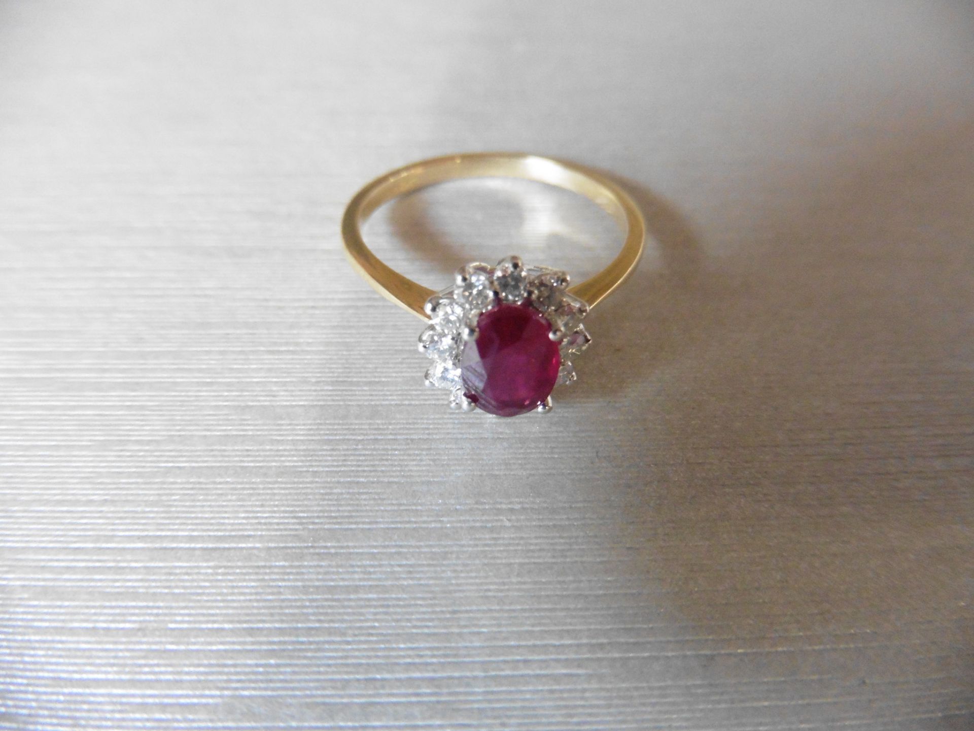 0.75ct / 0.30ct ruby and diamond cluster ring. Oval cut ( glass filled )ruby surrounded by small - Image 2 of 3