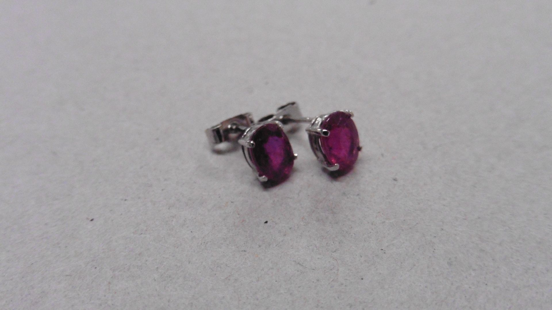 1.60ct ruby stud style earrings set in 9ct white gold. 7 x 5mm oval cut rubies ( glass filled )