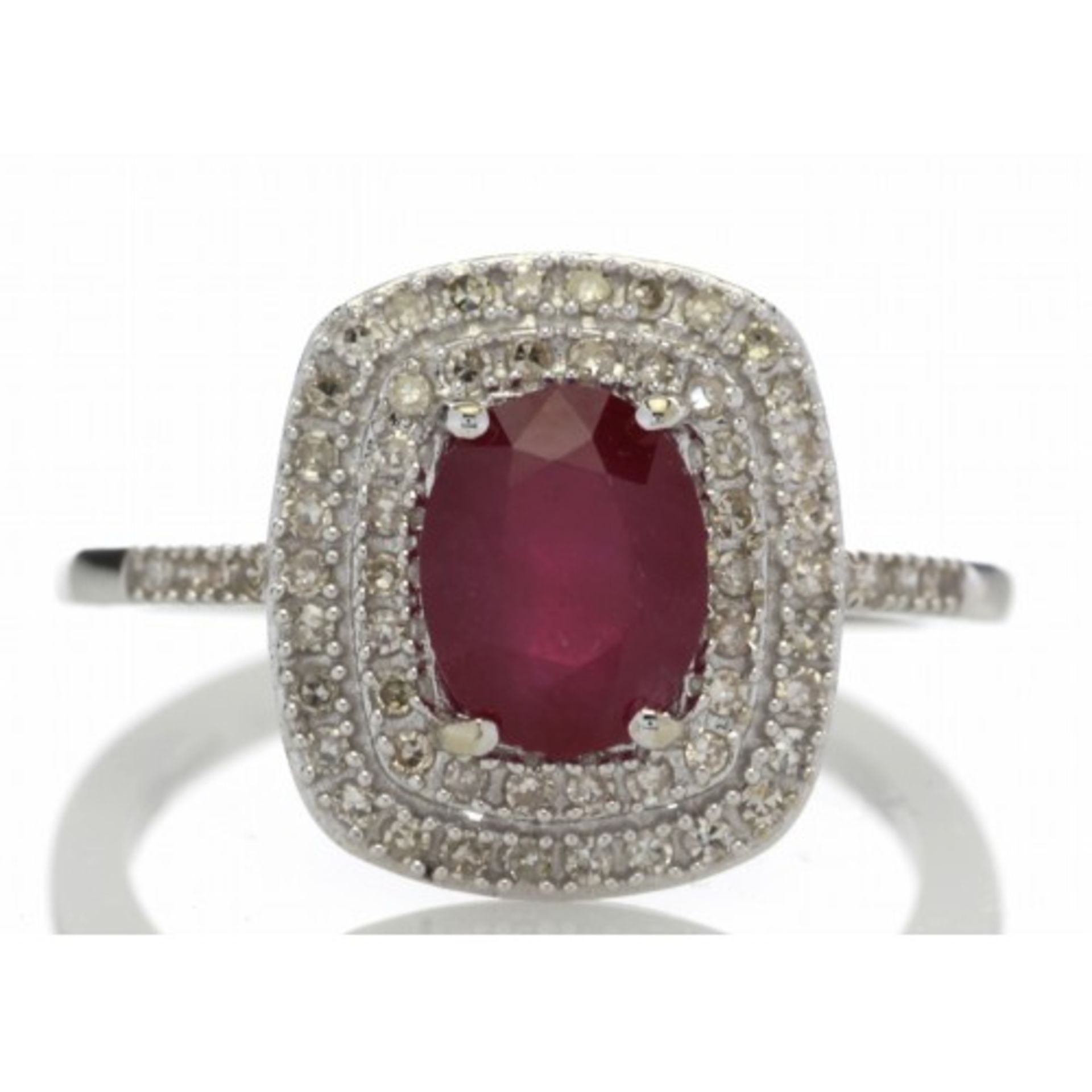 Ruby and diamond cluster dress ring set in 14ct gold. 1.54ct Oval cut ruby surrounded with a