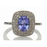 Tanzanite and diamond cluster dress ring set in 14ct gold. 1.29ct Oval cut tanzanite surrounded with